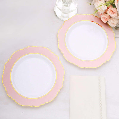 Elegant pink and gold rimmed dinner plates on a light background.