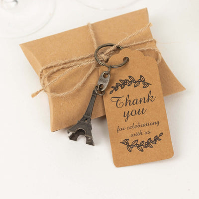 Eiffel Tower keychain with "Thank you for celebrating with us" tag on gift box.