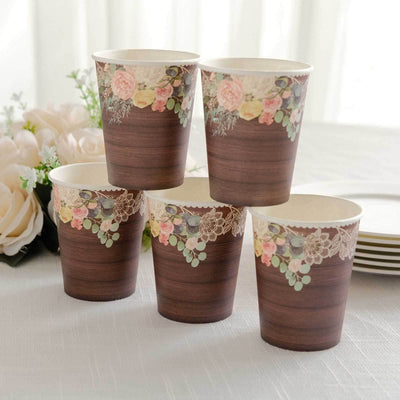 Set of five floral-themed disposable cups on a table.