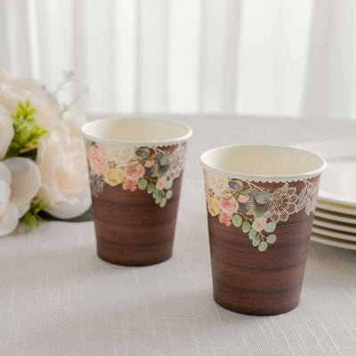 Floral design disposable cups on a table with white tablecloth.