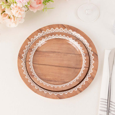Wooden plates with white lace design on a plain background.