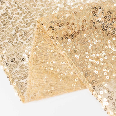 Gold sequin fabric with intricate patterns and shimmering details.