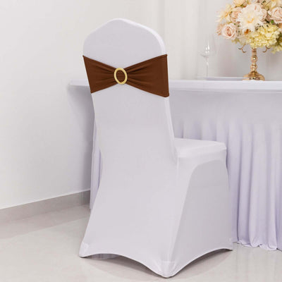 White chair cover with brown sash and decorative ring, styled for events.