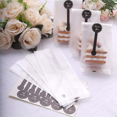 Thank you treat bags with stickers and cookies, elegantly displayed.