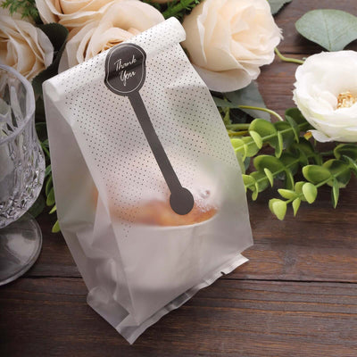 Transparent treat bag with a "Thank You" label, surrounded by flowers.
