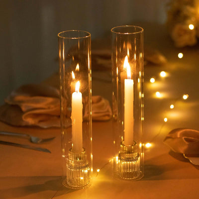 Elegant candle holders with lit candles and fairy lights.