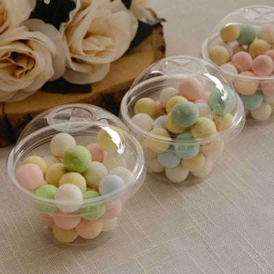 Colorful candy-coated chocolate balls in clear plastic cups.