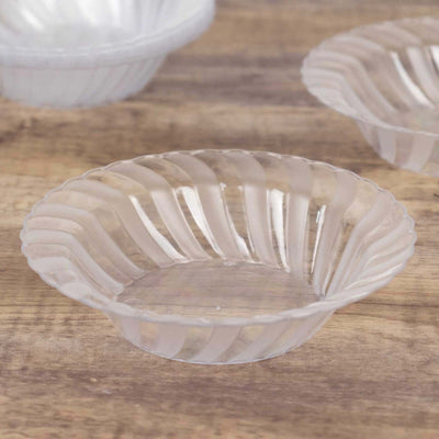 Clear plastic dessert bowls with wavy design for serving snacks or desserts.