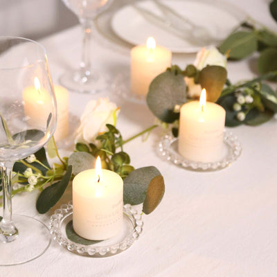 Elegant table setting with lit candles and floral decorations.