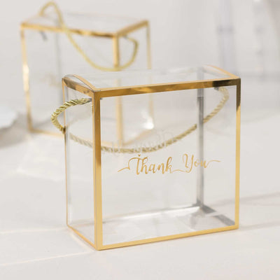 Clear gift box with gold accents and "Thank You" text.