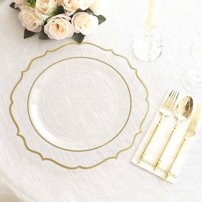 Elegant clear plate with gold trim, styled with cutlery and floral decor.