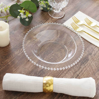 Clear glass plate with beaded rim on a wooden table setting.