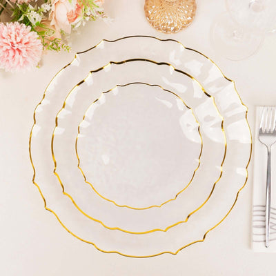 Elegant white plates with gold trim, arranged in a stacked display.