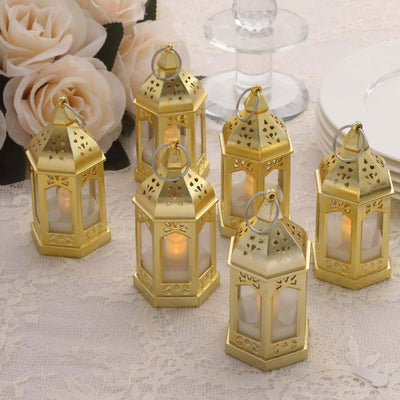 Set of six gold lanterns with candles, perfect for decor.