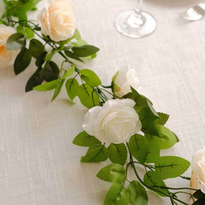 Artificial white roses and green leaves garland for decoration.