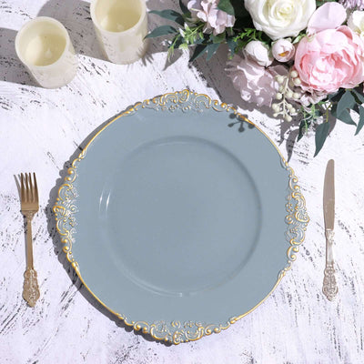 Decorative grey plate with gold trim, styled with silver cutlery and floral arrangement.