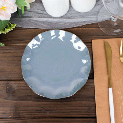 Gray ceramic plate with a scalloped edge on a wooden table setting.