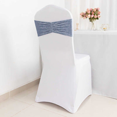 White chair cover with blue accent, set at a decorated table.