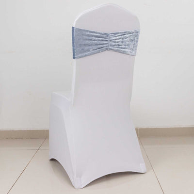 White chair cover with silver bow on a plain backdrop