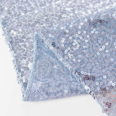 Light blue sequin fabric with shimmering details, showcasing texture and shine.