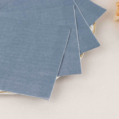 Gray textured paper sheets stacked on a plate.