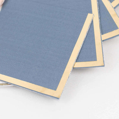 Blue notecards with gold borders stacked neatly.