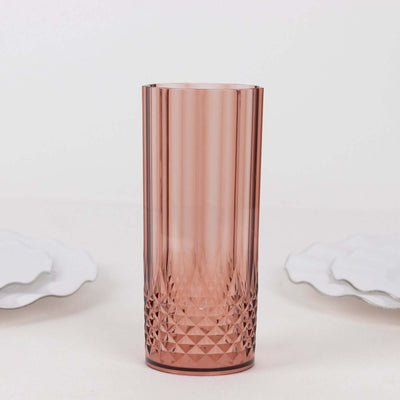 Pink geometric glass tumbler on a plain background