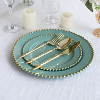 Elegant teal dinnerware set with gold accents on a dining table