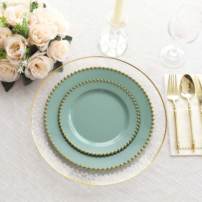 Elegant mint green plates with gold beading on a festive table setting.