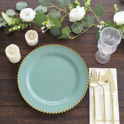 Elegant turquoise plate with gold beaded rim, surrounded by floral decor and candles.