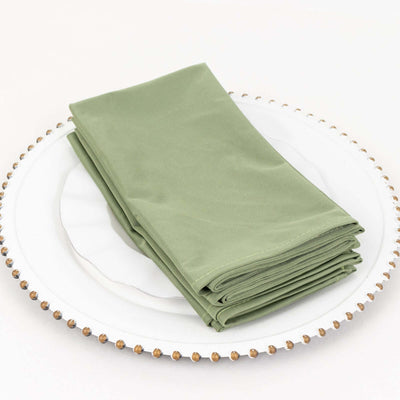 Folded green napkins on a decorative plate