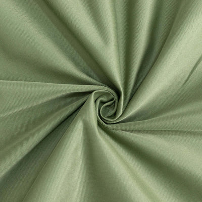 Green fabric texture in a swirling pattern.