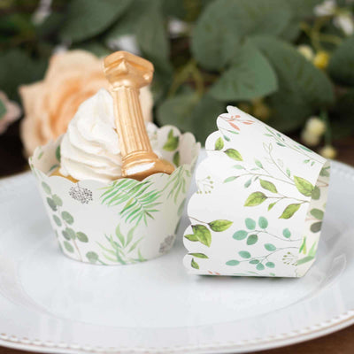Cupcake wrappers with floral designs on a decorative plate.