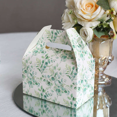 Floral gift box on a table with a bouquet of roses.