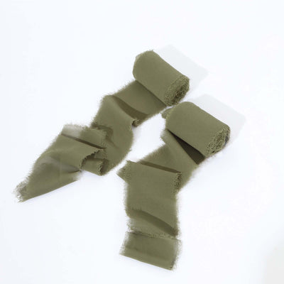 Olive green fabric rolls with frayed edges on a white background