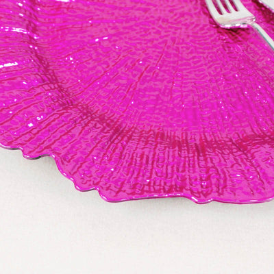 Glossy pink decorative plate with a textured design and fork