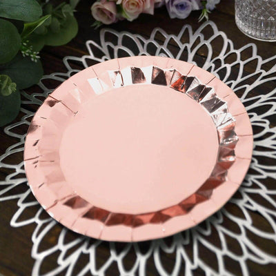 Rose gold paper plate on a decorative lace doily.