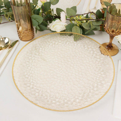 Elegant hammered glass serving platter with gold rim and floral decor.