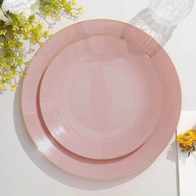 Elegant pink plates with gold trim stacked on a light surface.
