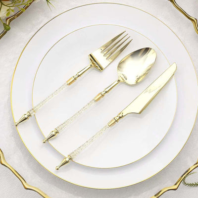 Elegant gold cutlery set with crystal handle accents on a white plate.