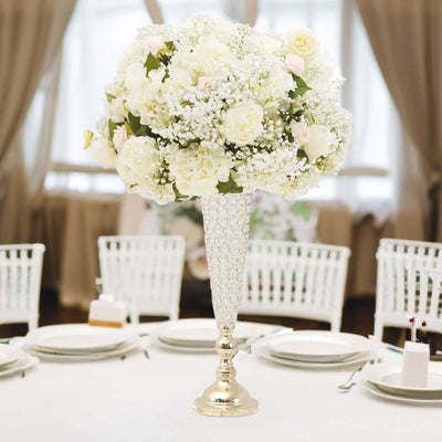 Elegant floral centerpiece with white roses and baby's breath in a crystal vase.