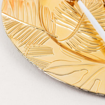 Gold leaf plate with intricate leaf pattern design.