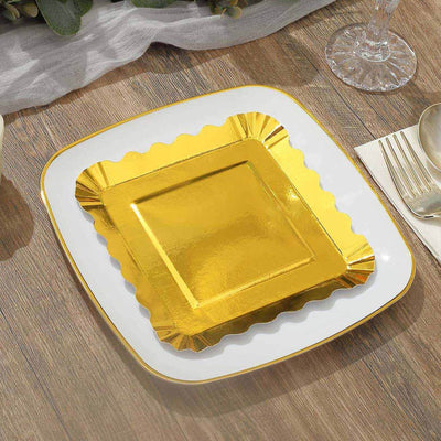 Gold square plate with scalloped edges on a wooden table.