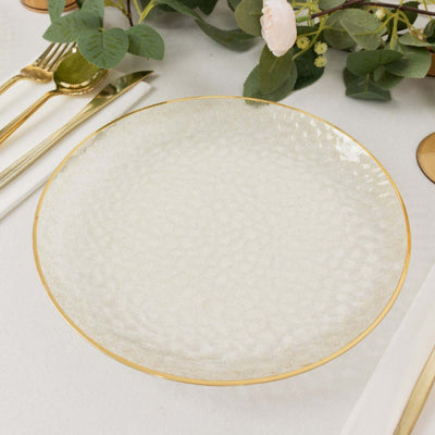 Elegant glass plate with textured surface and gold rim.