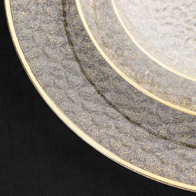 Elegant clear glass plates with gold trim and textured design.