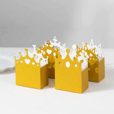Golden crown-shaped gift boxes on a white background.