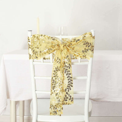 Gold sequin chair sash tied in a bow on a white chair.