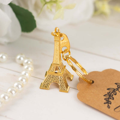 Eiffel Tower keychain with a gold finish and a decorative tag