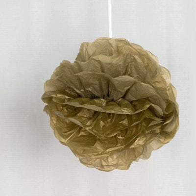Gold tissue paper flower decoration hanging from a string.