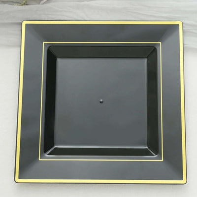 Black square plate with yellow trim, studio shot.